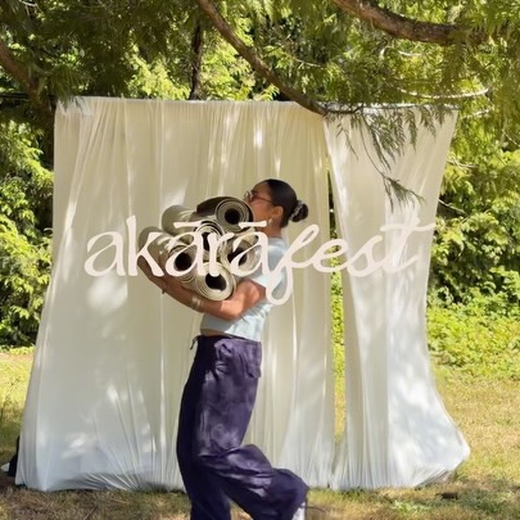 Dancer in front of the Akārā-fest backdrop — August 16th event featuring Krave