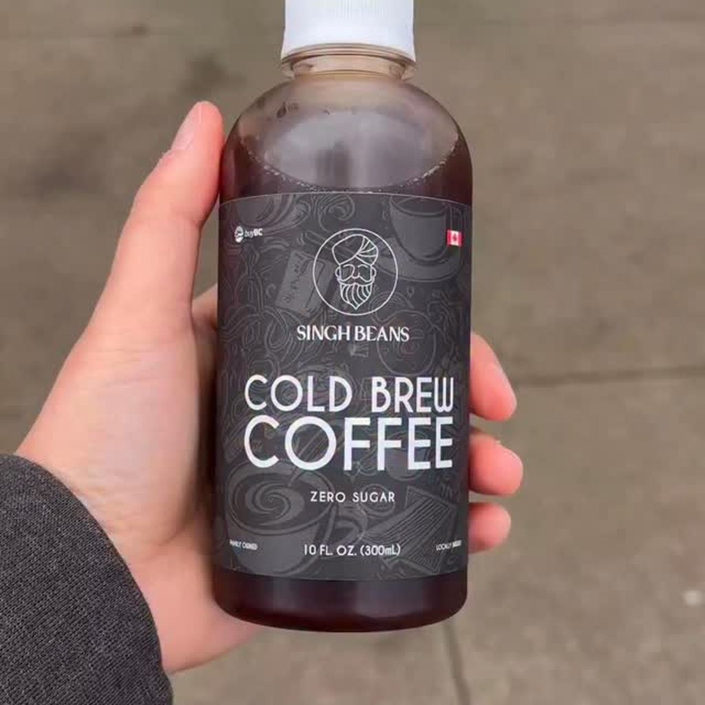 Hand holding a bottle of Singh Beans zero-sugar cold brew coffee sold at Krave